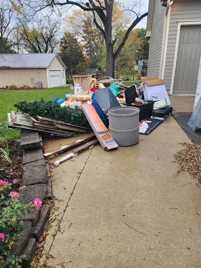 Dumpster being loaded with debris for Demolition Dumpster Rental in Northport